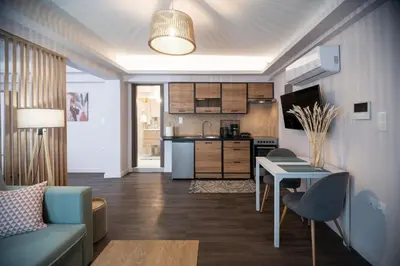 a kitchen and living room with a couch and a table at Niki Athens Suites - Cosy Suite in Monastiraki Historical Centre in Athens