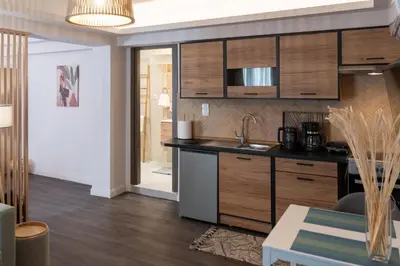 a kitchen with wooden cabinets and a counter top at Niki Athens Suites - Cosy Suite in Monastiraki Historical Centre in Athens