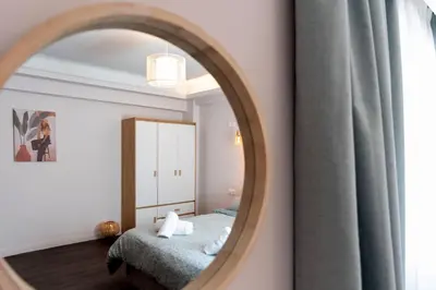 a bedroom with a bed and a mirror at Niki Athens Suites - Cosy Suite in Monastiraki Historical Centre in Athens