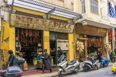 a group of people walking in front of a store at Niki Athens Suites - Cosy Suite in Monastiraki Historical Centre in Athens