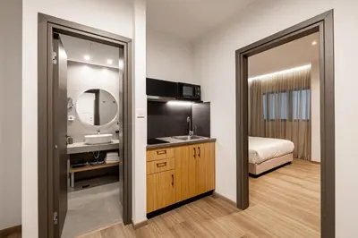 a bathroom with a sink and a mirror at Pnoe Urban Living in Athens