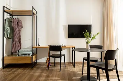 a dining room with a desk and a table and chairs at Pnoe Urban Living in Athens