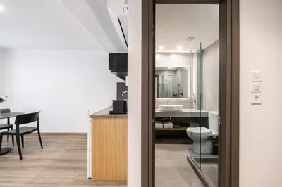 a bathroom with a toilet and a sink in a room at Pnoe Urban Living in Athens