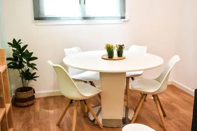 a white table and chairs in a room with a plant at Newly renovated-City Center Apartment in Athens