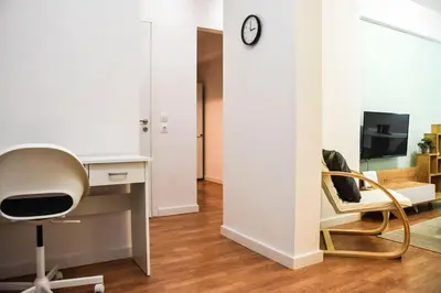 a living room with a desk and a chair at Newly renovated-City Center Apartment in Athens