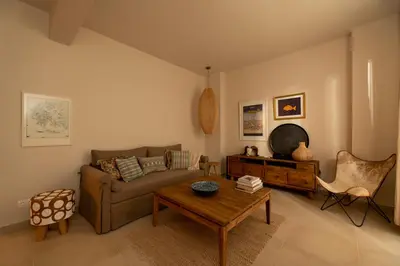 a living room with a couch and a table at Alios, Luxury Living Athens in Athens