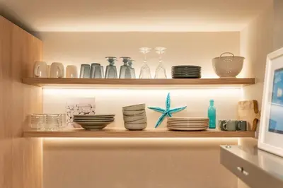 a shelf with bowls and plates on it at Alios, Luxury Living Athens in Athens