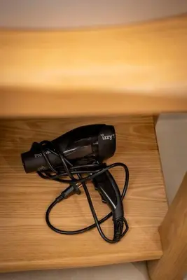 a black hair dryer sitting on top of a table at Alios, Luxury Living Athens in Athens