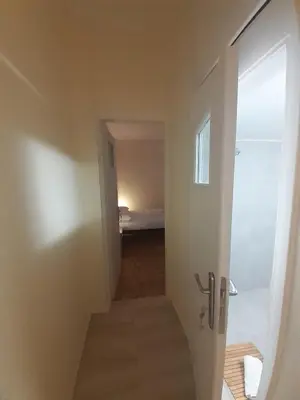 a hallway with a door leading to a bedroom at A Apartments in Athens