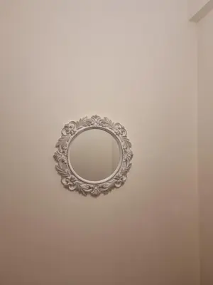 a mirror hanging on a white wall at A Apartments in Athens
