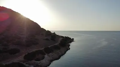 an island in the ocean with the sun shining on it at Endless Seaview in Porto Rafti