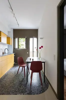 a kitchen and dining room with a table and two chairs at Nileos House in Athens
