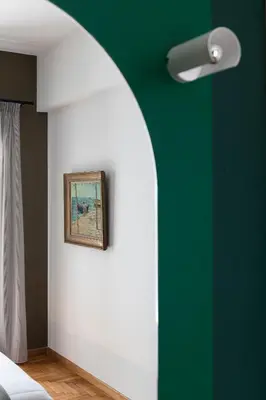 a room with a green wall and a picture on the wall at Nileos House in Athens
