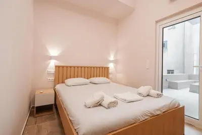 a bedroom with a bed with two pillows on it at The Downtown Oasis [4' To Panormou Metro Station] in Athens