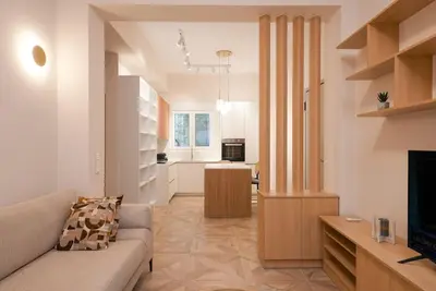 a living room with a couch and a television at The Downtown Oasis [4' To Panormou Metro Station] in Athens