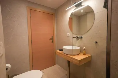 a bathroom with a sink and a mirror and a toilet at The Downtown Oasis [4' To Panormou Metro Station] in Athens