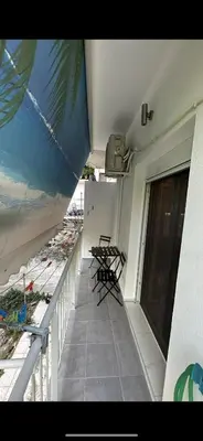 a balcony with chairs and tables on a building at HP Studio Luxury Apartment in Athens