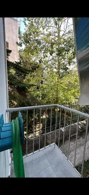 a porch with a fence and a tree at HP Studio Luxury Apartment in Athens