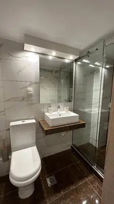 a bathroom with a white toilet and a sink at HP Studio Luxury Apartment in Athens