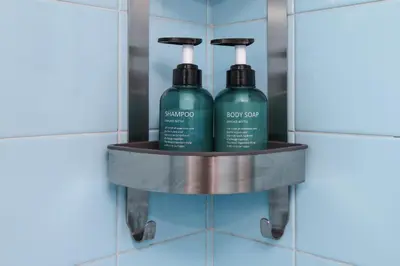 two bottles of shampoo on a shelf in a bathroom wall at Your Perfect Place 1min from Kato Patissia Station -100Mbps in Athens