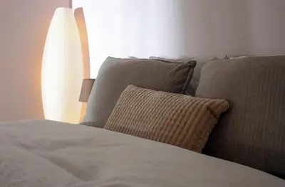 a bed with two pillows next to a window at Your Perfect Place 1min from Kato Patissia Station -100Mbps in Athens