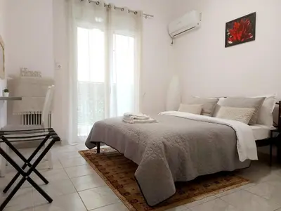 a white bedroom with a bed and a window at Your Perfect Place 1min from Kato Patissia Station -100Mbps in Athens