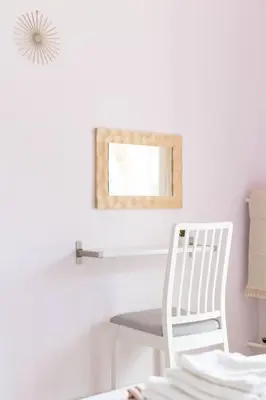 a white chair sitting next to a table with a mirror at Your Perfect Place 1min from Kato Patissia Station -100Mbps in Athens