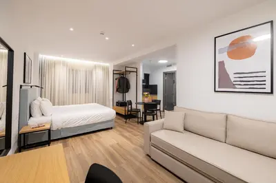 a hotel room with a bed and a couch at Earos Urban Living in Athens
