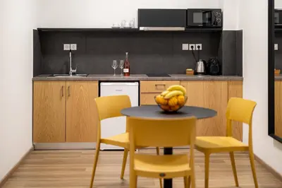 a kitchen with a table with a bowl of bananas on it at Earos Urban Living in Athens