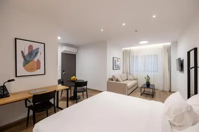 a hotel room with a bed and a desk at Earos Urban Living in Athens