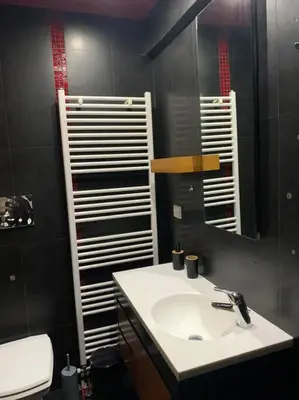 a bathroom with a sink and a mirror at Varkiza Lux Apartment in Varkiza
