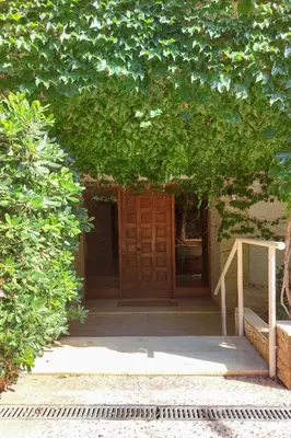 an entrance to a building with a wooden door at Naiads Nest - The Comfort Lux in Varkiza