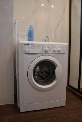 a white washing machine sitting in a room at Naiads Nest - The Comfort Lux in Varkiza