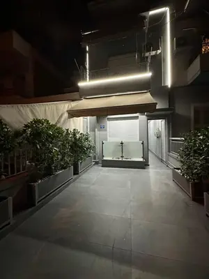 an empty hallway with potted plants in a building at Kris boy in Athens