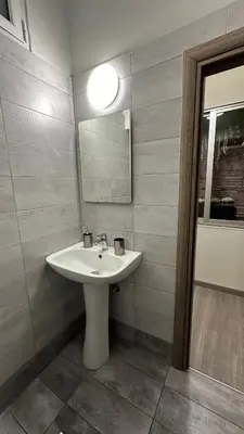 a bathroom with a white sink and a mirror at Kris boy in Athens