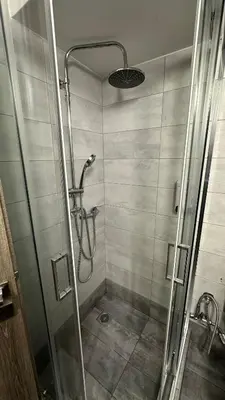 a shower with a glass door in a bathroom at Kris boy in Athens