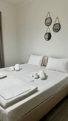 a large white bed with towels on top of it at Kris boy in Athens