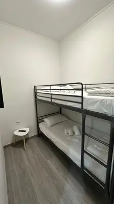 a room with two bunk beds and a stool at Kris boy in Athens