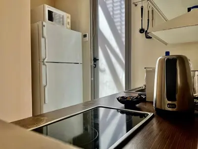 a kitchen with a counter top with a refrigerator at Monastiraki Loft AthensApart in Athens