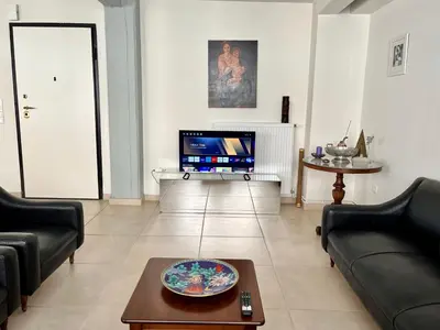 a living room with two couches and a tv at Monastiraki Loft AthensApart in Athens