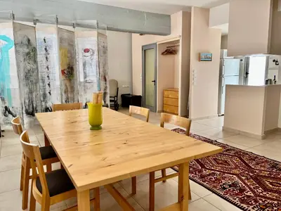 a wooden table in a room with a kitchen at Monastiraki Loft AthensApart in Athens