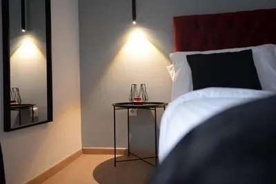 a bedroom with a bed and a table with glasses on it at Penthouse in the Heart of Athens in Athens