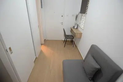 a living room with a couch and a desk and a chair at Penthouse in the Heart of Athens in Athens