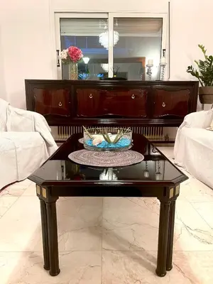a living room with a coffee table and a couch at Emerald Luxury Apartments - ATH Airport in Spáta