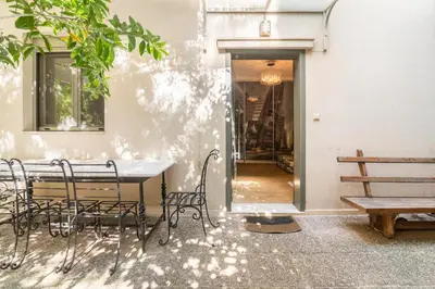 a table and chairs in front of a building at Pop Art Home - Experience Local Vibes in Athens