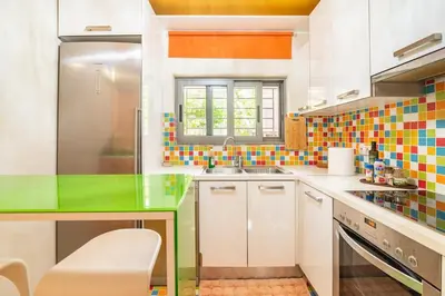 a kitchen with colorful tiles on the wall at Pop Art Home - Experience Local Vibes in Athens