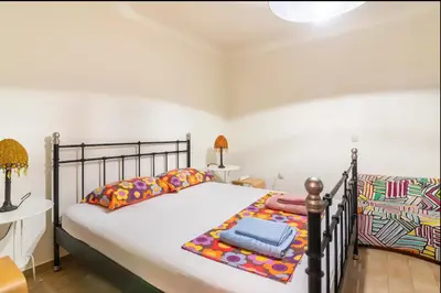 a bedroom with a large bed and a table at Pop Art Home - Experience Local Vibes in Athens