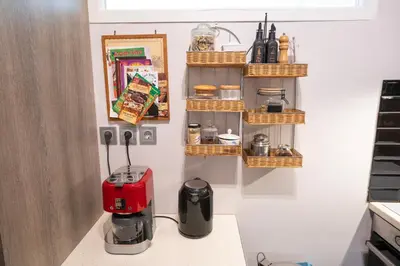 a kitchen with a counter with a coffee maker and baskets at Angel Apartment in Athens