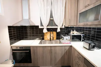 a kitchen with a sink and a microwave at Angel Apartment in Athens