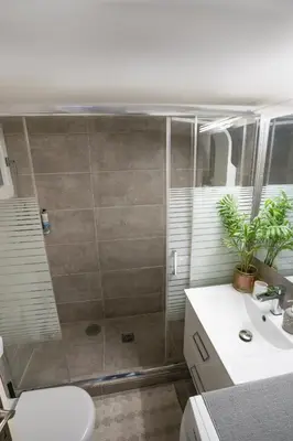 a bathroom with a shower and a toilet and a sink at Angel Apartment in Athens